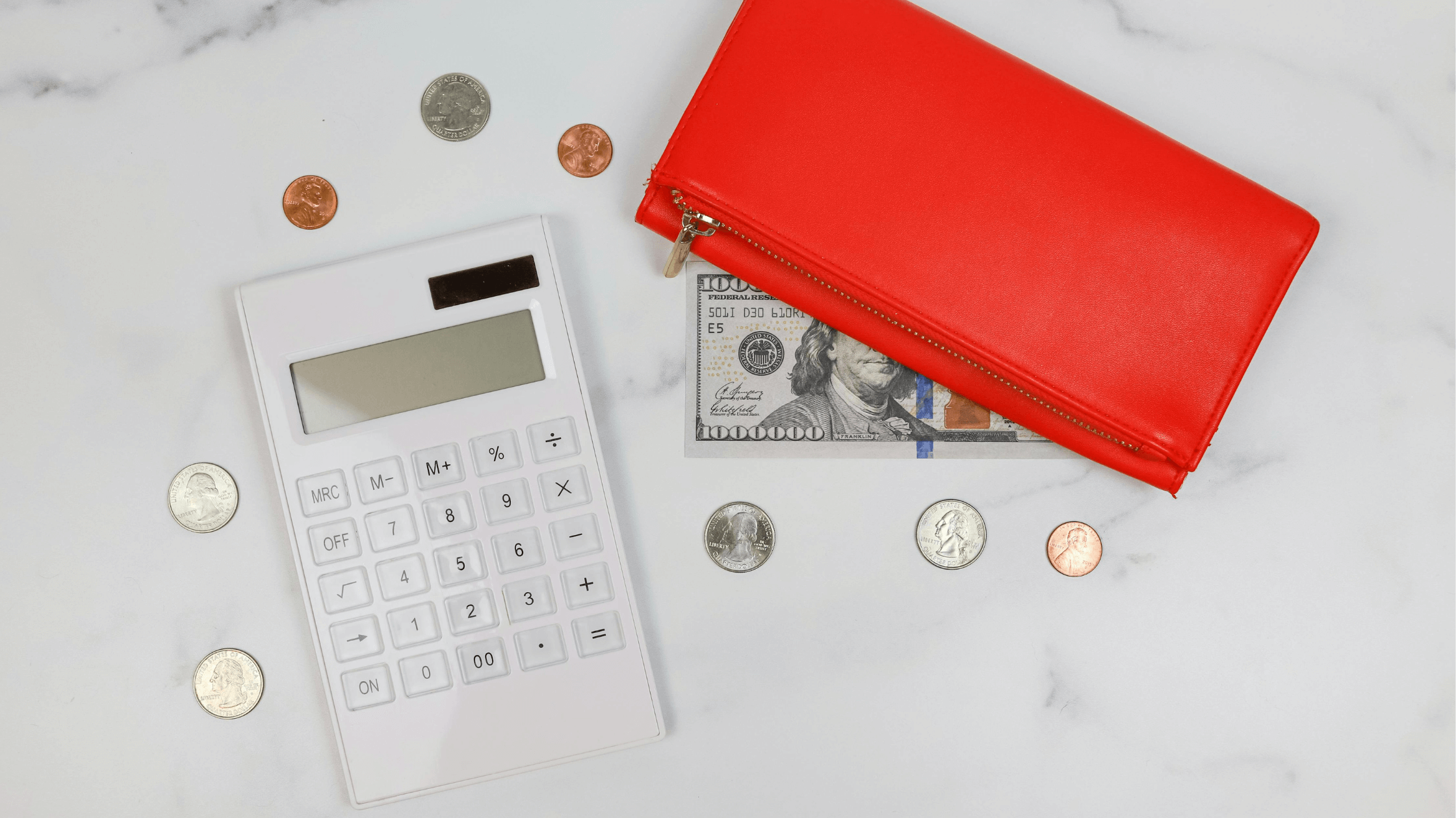 Calculator and coins displayed on a desk