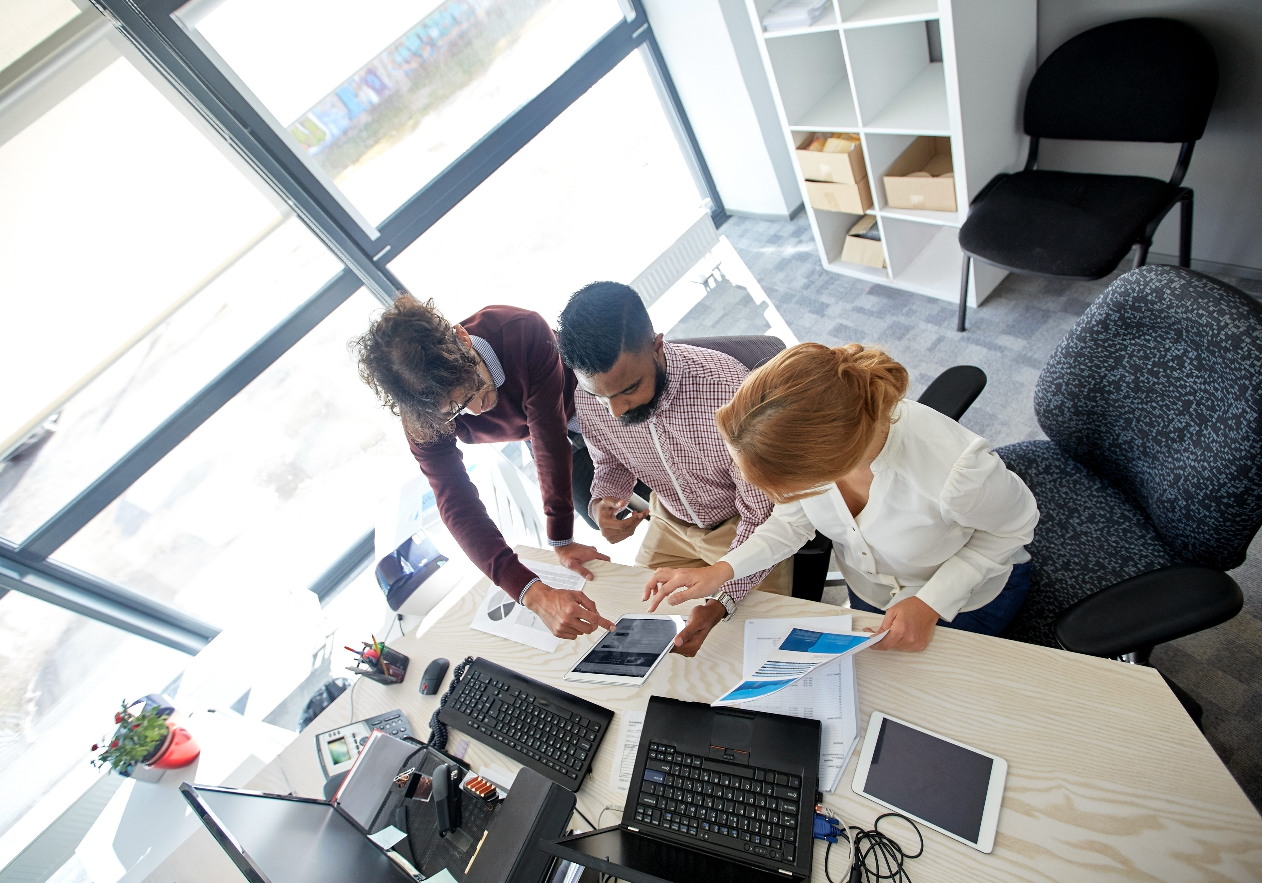 business-team-with-tablet-pc-and-papers-at-office-P4JU6H3-landscape